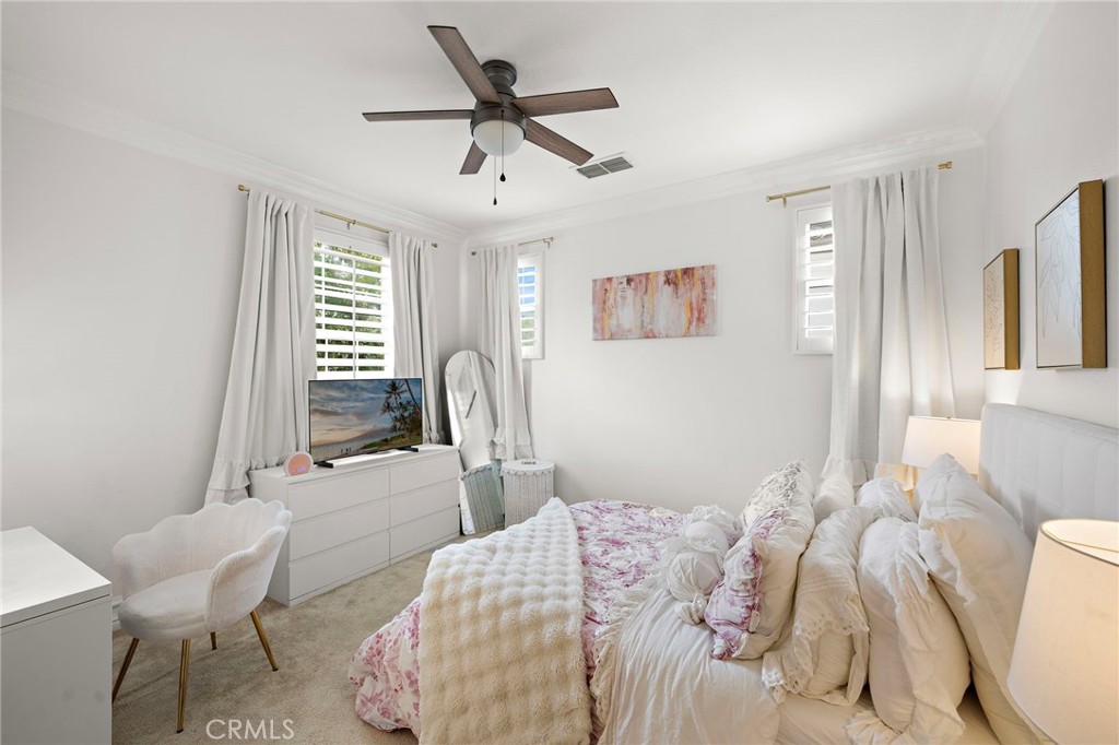 33 Christopher Street Ladera Ranch, CA 92694 - Photo 36 of 58 a bedroom with a bed and a chair