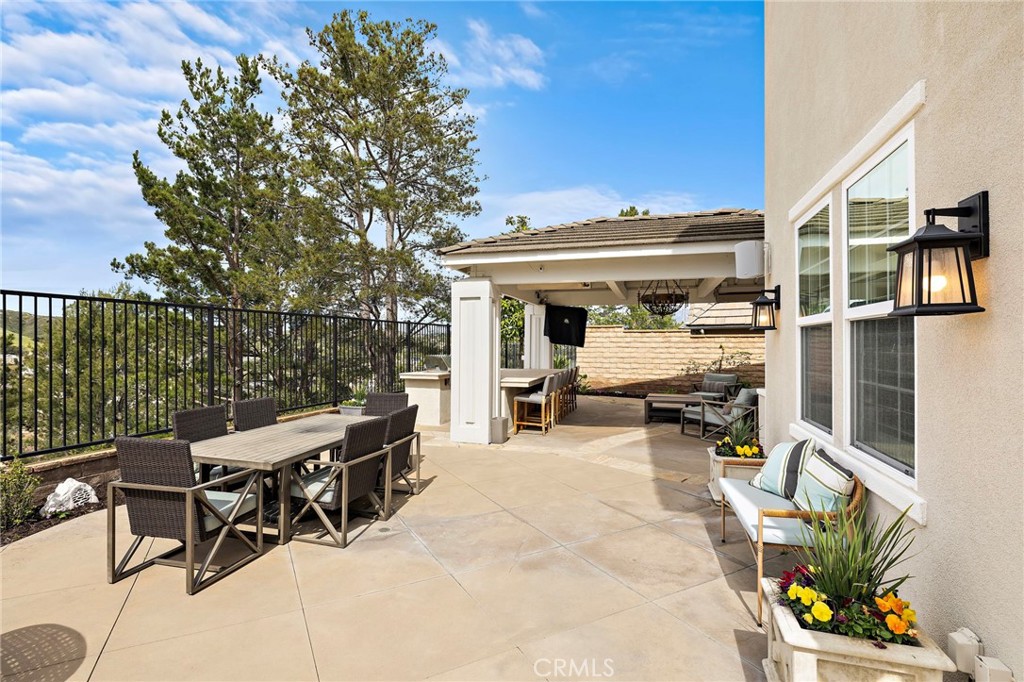 33 Christopher Street Ladera Ranch, CA 92694 - Photo 39 of 58 a view of a patio with a table and chairs under an umbrella