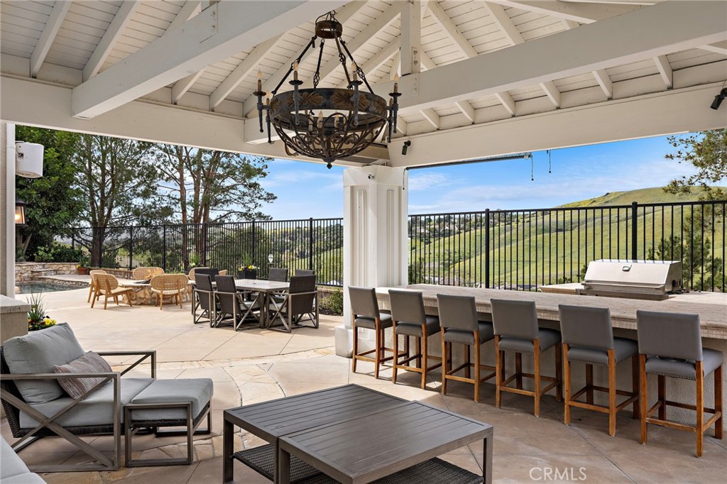33 Christopher Street Ladera Ranch, CA 92694 - Photo 41 of 58 a view of a patio with a dining table and chairs