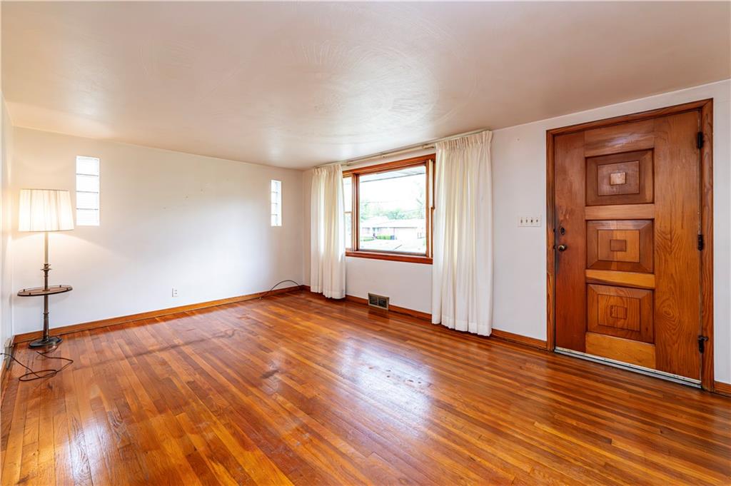 13740 Ridge Road Irwin, PA 15642 - Photo 4 of 43 an empty room with wooden floor and windows