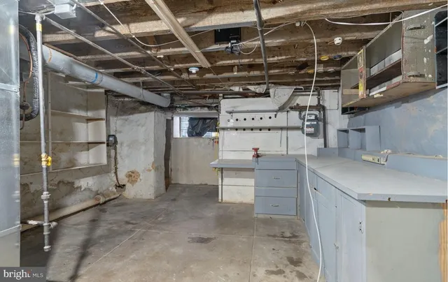 a utility room with cabinets dryer and windows