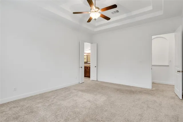 an empty room with closet and windows