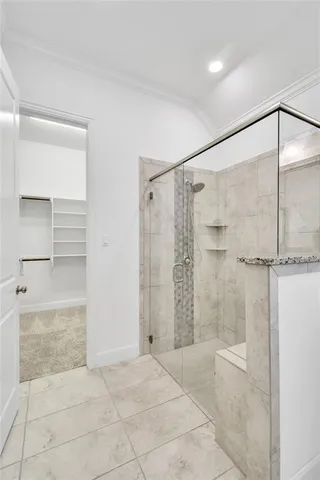a bathroom with a glass shower door