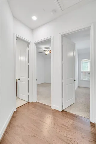 an empty room with wooden floor and mirror