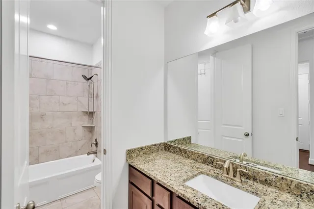 a white toilet and tub sitting next to a bathroom sink