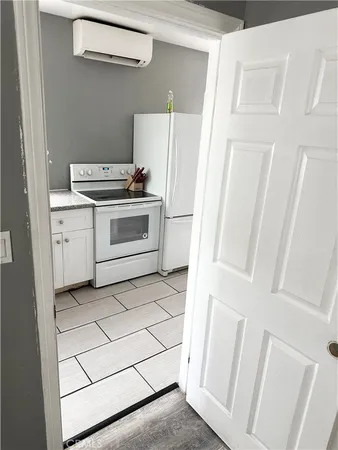 a kitchen with white cabinets and white appliances