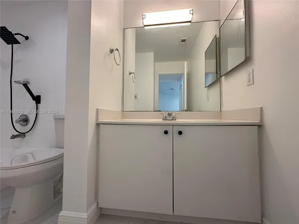 a bathroom with a toilet and a bath tub