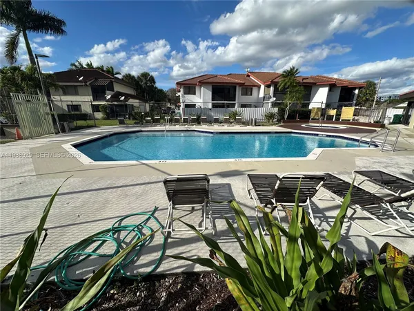 a view of multiple houses with a swimming pool