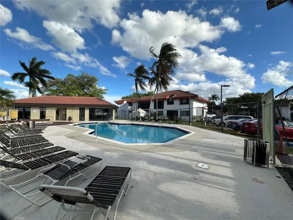 a view of a house with backyard porch and sitting area