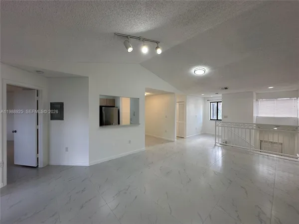 an empty room with a empty space and windows