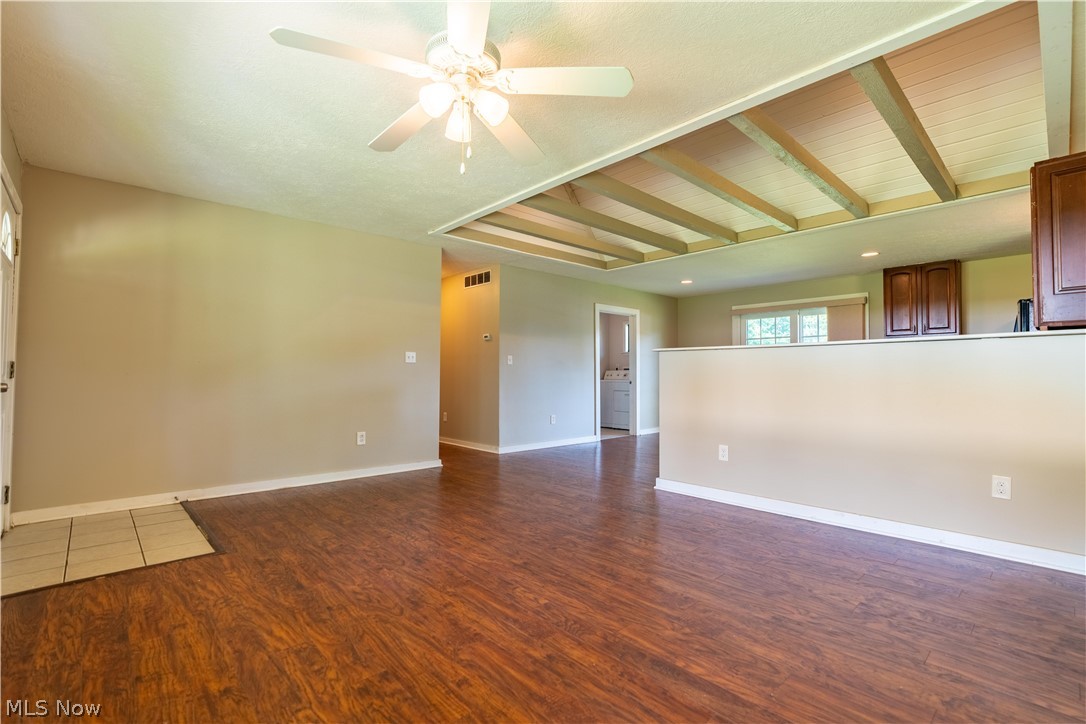 1889 Ronald Road Akron, OH 44312 - Photo 12 of 36 Tiled spare room featuring beamed ceiling and ceiling fan