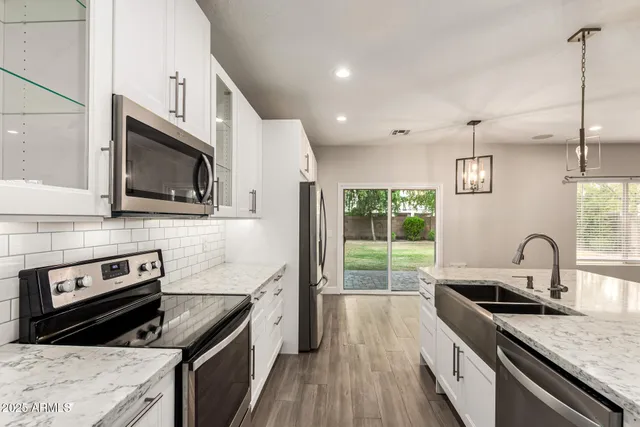 a kitchen with a sink stove and microwave
