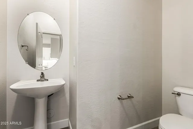 a bathroom with a sink a mirror and toilet