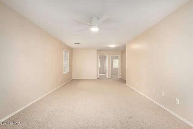 an empty room with a empty space and windows