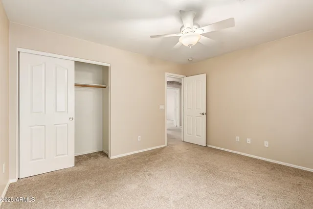 a view of an empty room with a ceiling fan