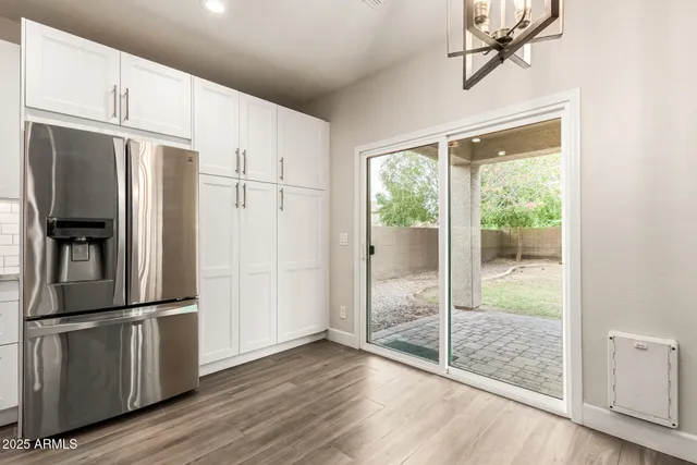 a kitchen with stainless steel appliances granite countertop a refrigerator and a sink