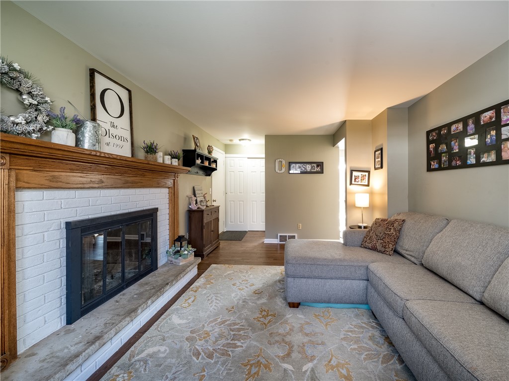 52 Lambeth Loop Perinton, NY 14450 - Photo 12 of 34 Family room and cosy wood burning fireplace and se