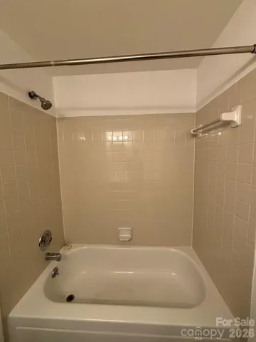 a bathroom with a shower and a bath tub