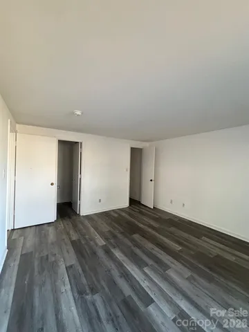 a view of a room with wooden floor