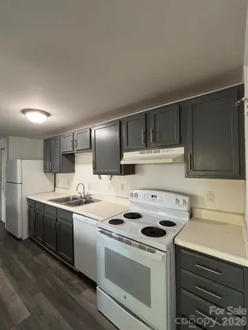 a kitchen with a stove sink and cabinets