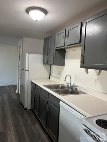 a kitchen with stainless steel appliances a sink and a refrigerator