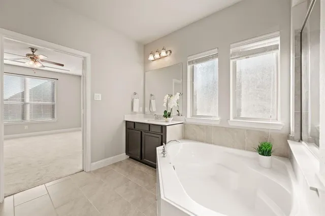 a white bath tub sitting in a bathroom next to a sink