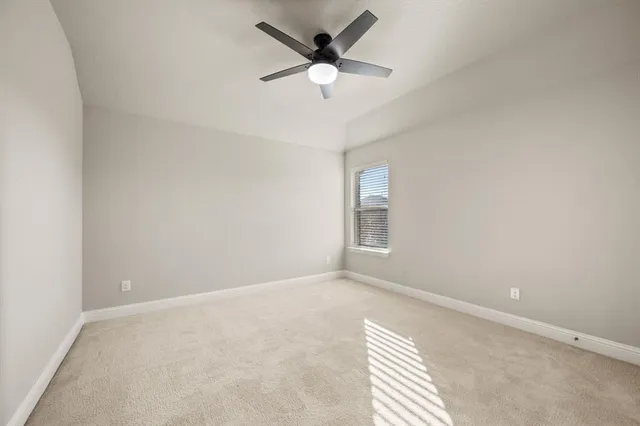 a bathroom with a bathtub shower sink vanity mirror and toilet