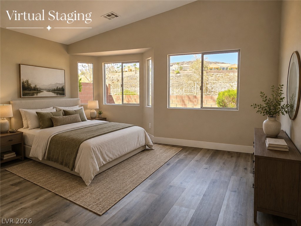 2278 Chestnut Ranch Avenue Henderson, NV 89052 - Photo 9 of 18 Slanted ceilings and ample windows create an open, airy atmosphere in this inviting primary bedroom.