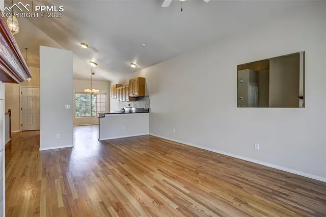 a view of a kitchen with a sink and a refrigerator
