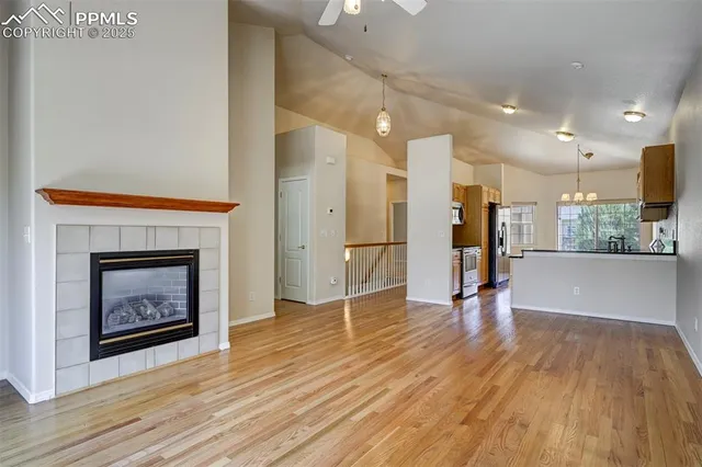 a view of a room with wooden floor and a fireplace