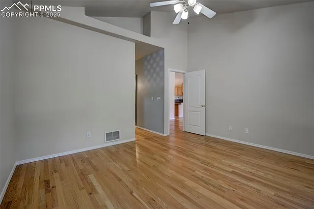 a view of an empty room with wooden floor