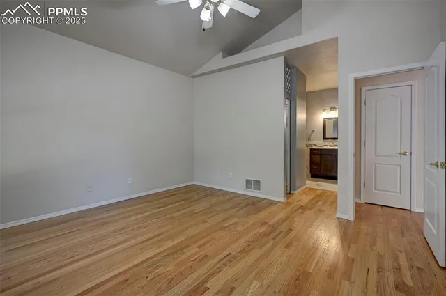 a view of empty room with wooden floor