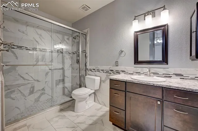 a bathroom with a sink toilet and shower