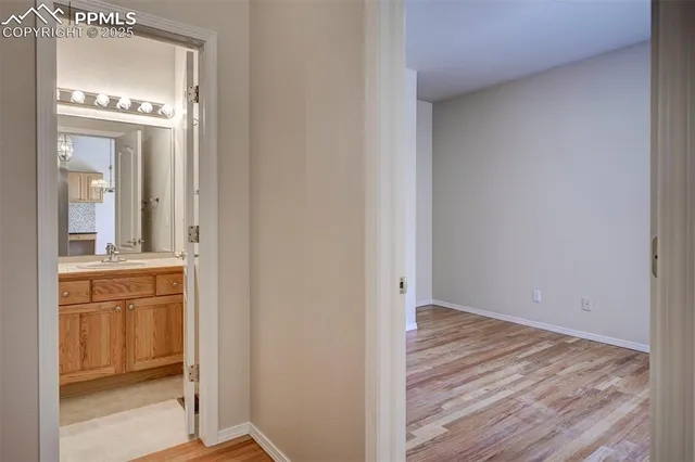 an empty room with wooden floor and a window