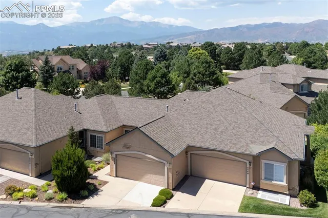 an aerial view of a house with a yard