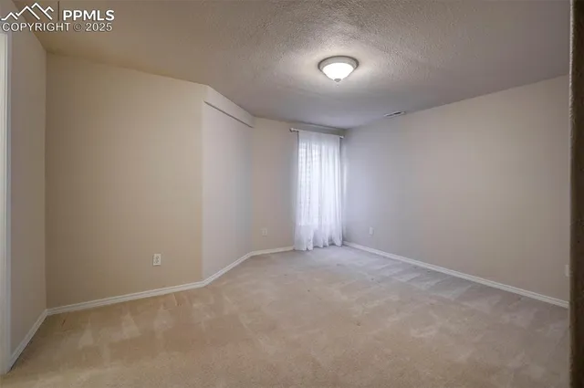 an empty room with closet area