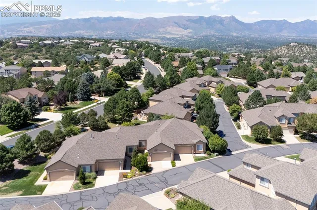 an aerial view of a house with a street