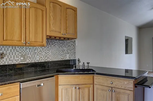 a kitchen with granite countertop white cabinets and sink