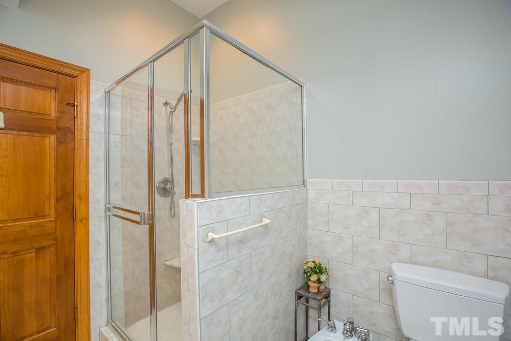 11709 Coachmans Way Raleigh, NC 27614 - Photo 14 of 25 a bathroom with a shower and a toilet