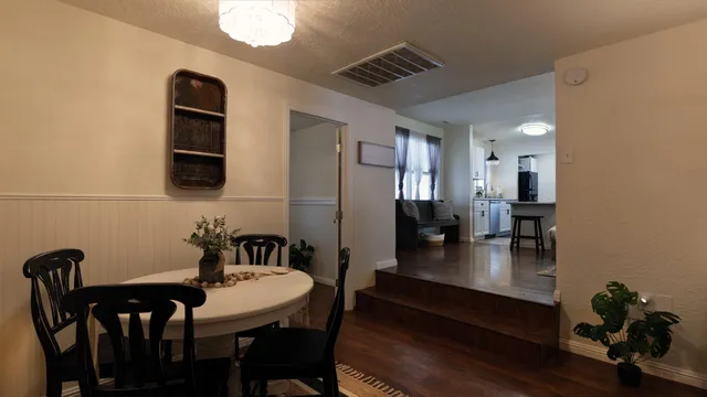a dining room with furniture and wooden floor