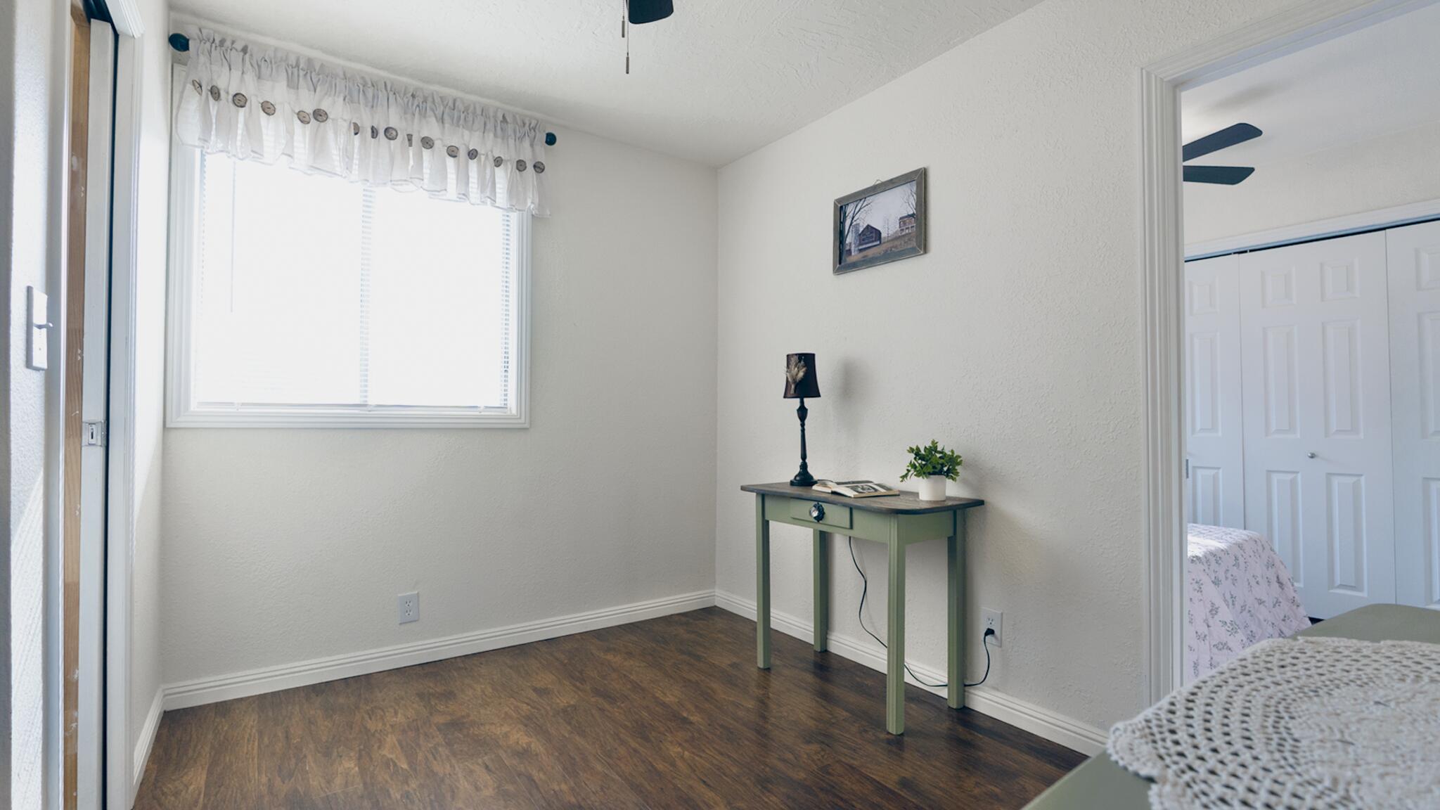 20577 Sunset Lane Redding, CA 96002 - Photo 14 of 29 a view of an empty room with a window and wooden floor
