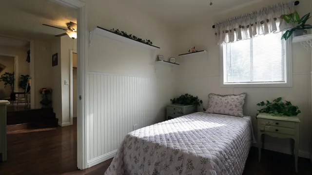 a bedroom with a bed and a window