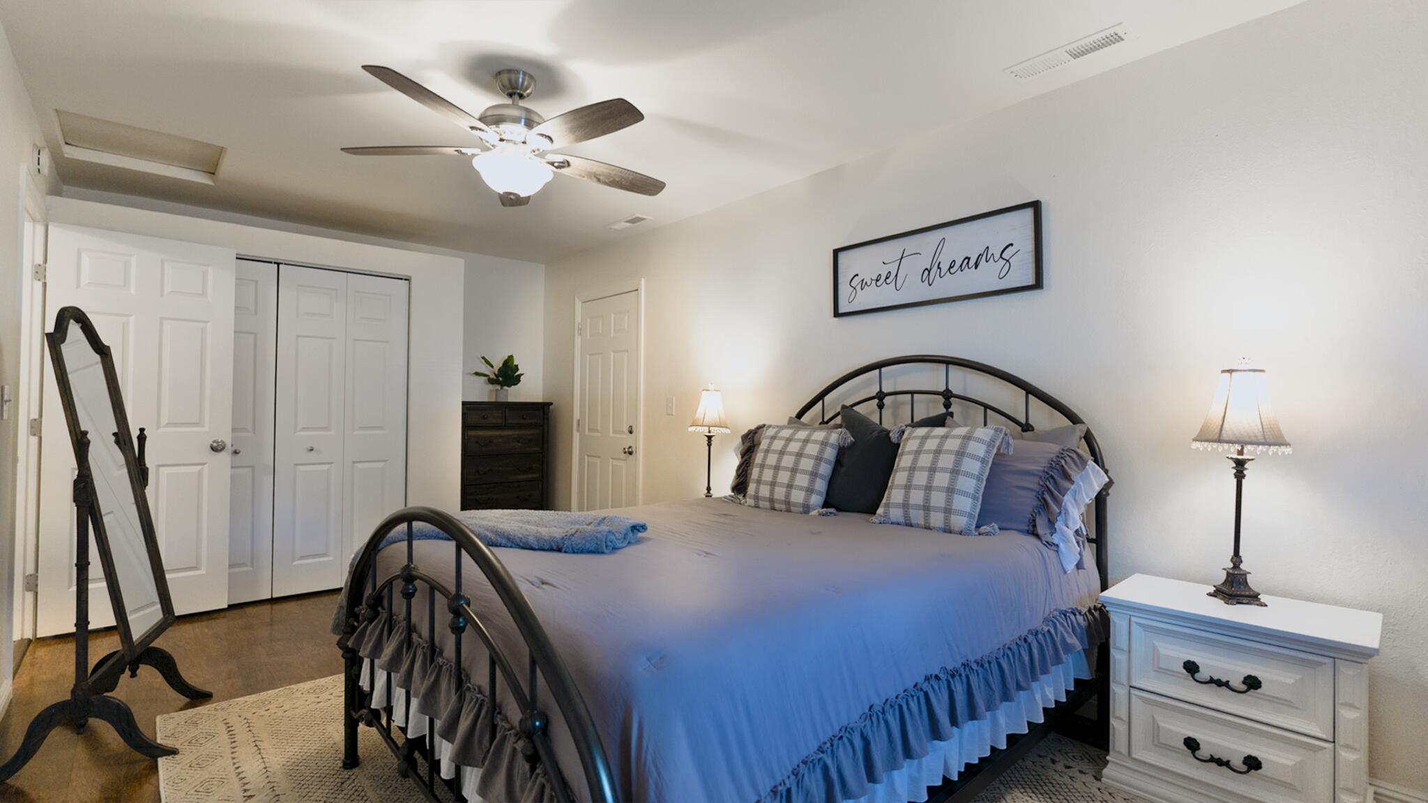20577 Sunset Lane Redding, CA 96002 - Photo 19 of 29 a bedroom with a bed and a chandelier
