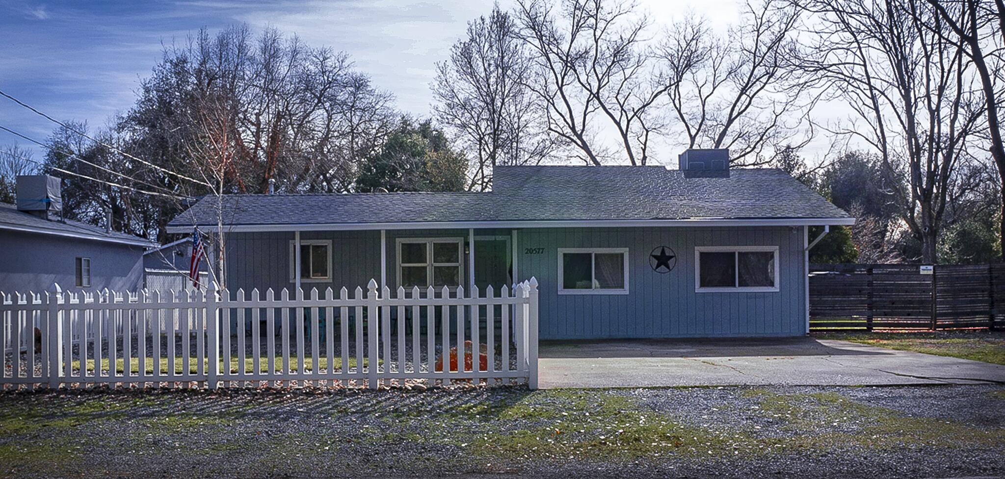 20577 Sunset Lane Redding, CA 96002 - Photo 2 of 29 a front view of a house with a yard