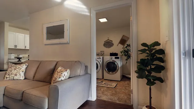 a living room with furniture and a mirror