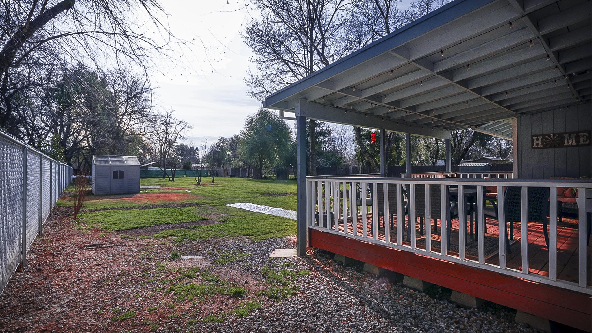 20577 Sunset Lane Redding, CA 96002 - Photo 25 of 29 a view of a backyard with wooden fence