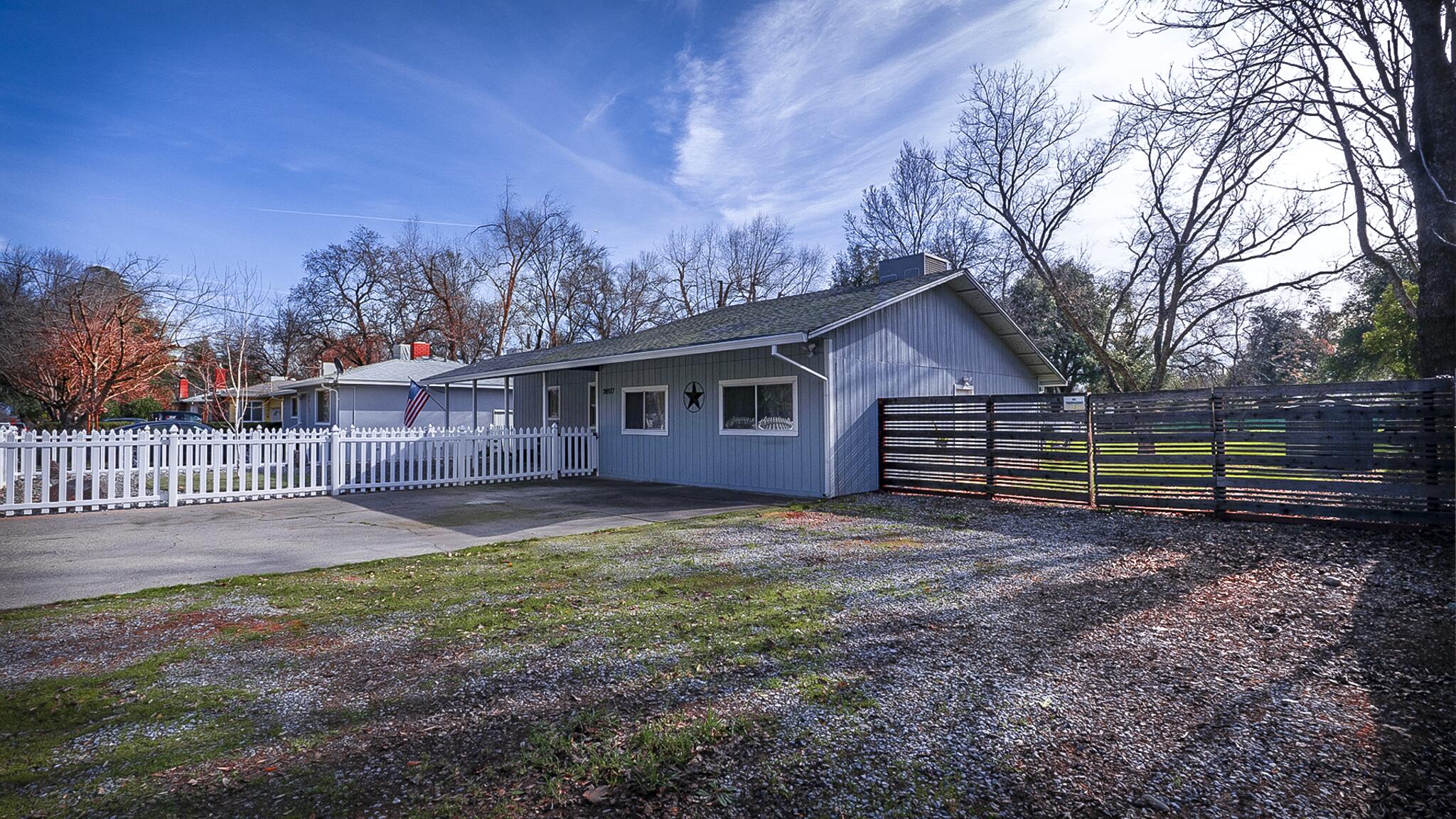 20577 Sunset Lane Redding, CA 96002 - Photo 3 of 29 a view of a house with a yard and wooden fence