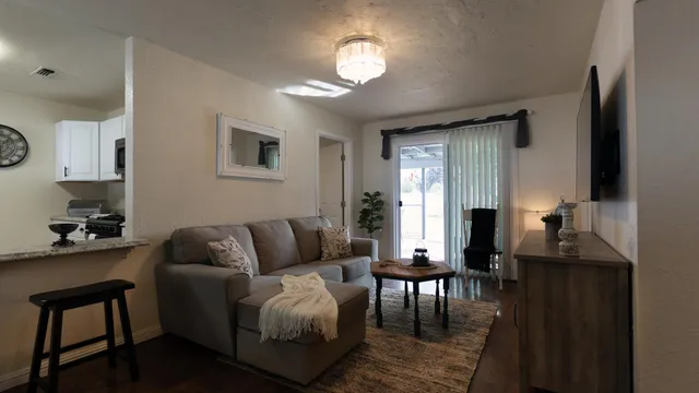 a living room with furniture and a chandelier