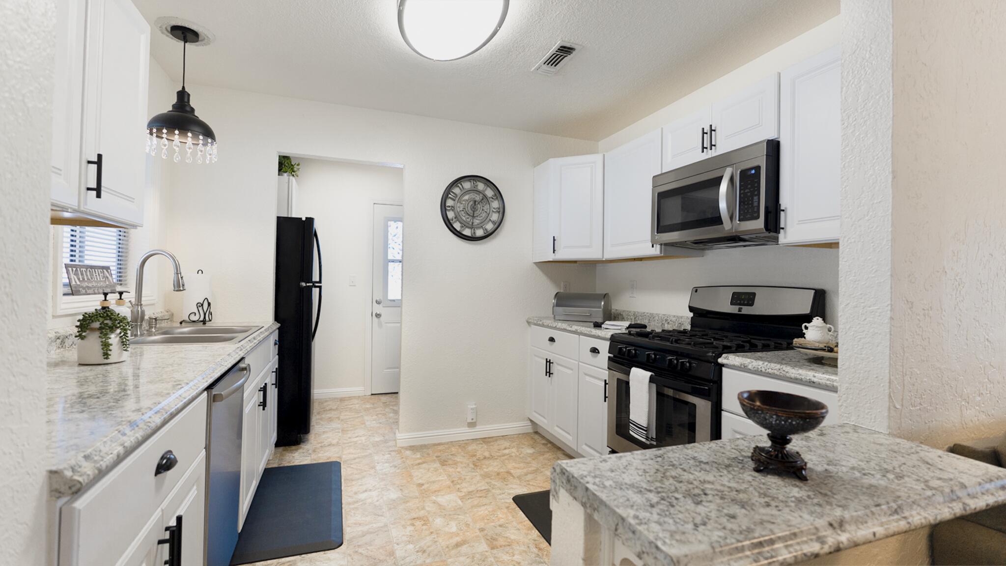 20577 Sunset Lane Redding, CA 96002 - Photo 7 of 29 a kitchen with stainless steel appliances granite countertop a sink stove and refrigerator