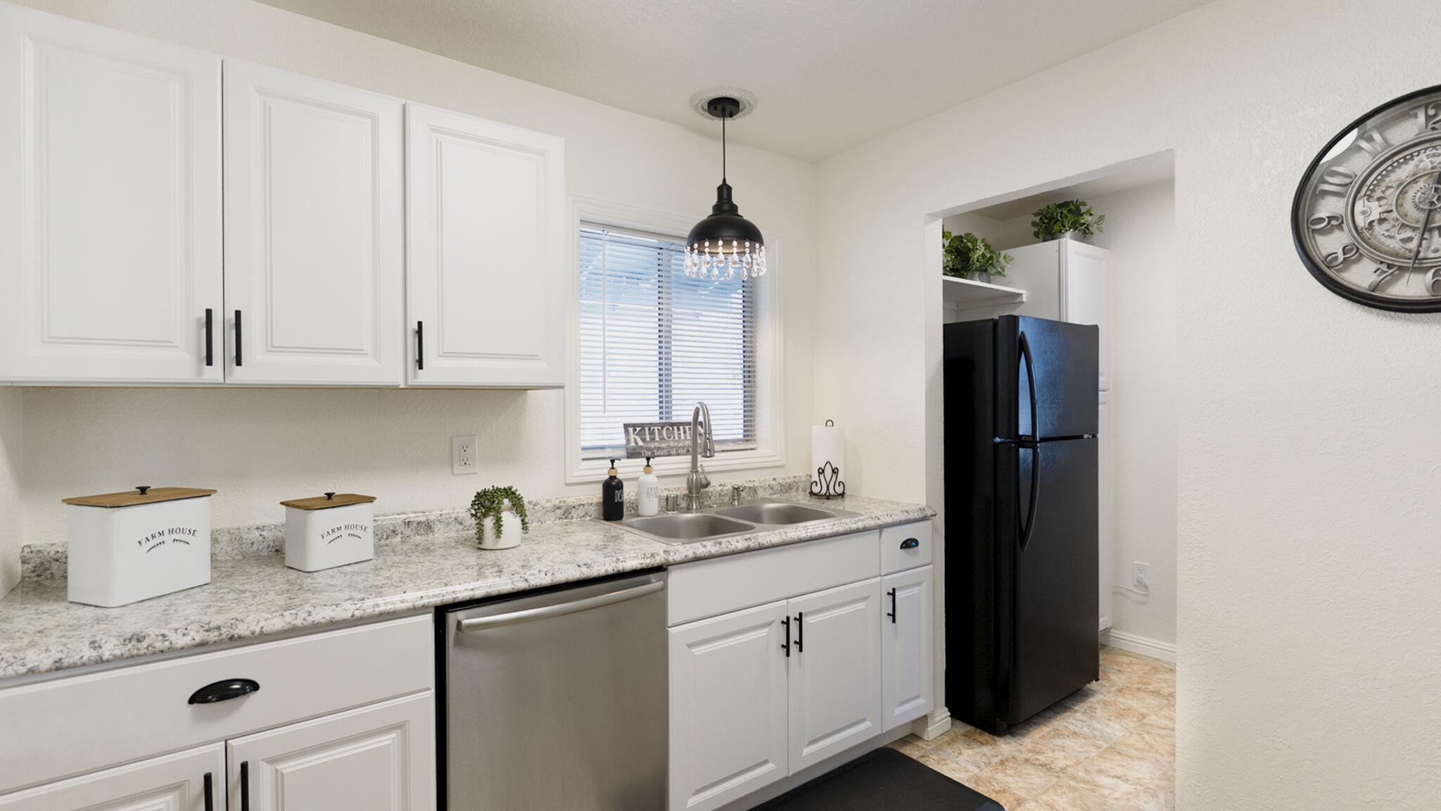 20577 Sunset Lane Redding, CA 96002 - Photo 8 of 29 a kitchen with granite countertop white cabinets and stainless steel appliances